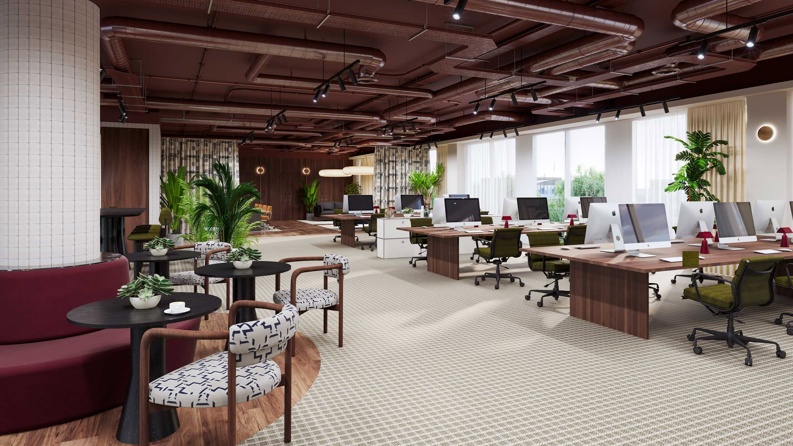 An open-plan office space features decor with workstations equipped with computers and potted plants