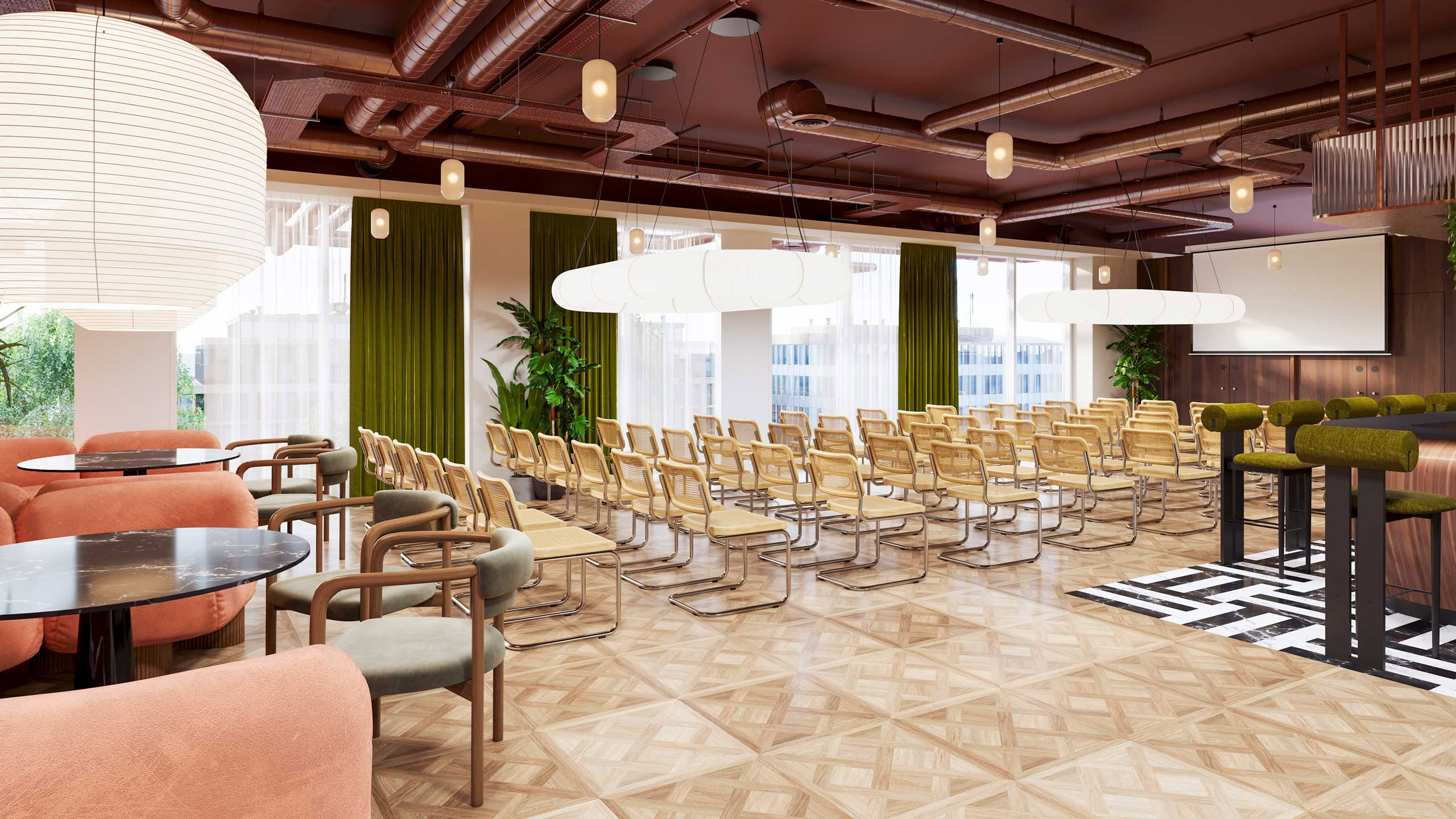 A conference room within an office building features rows of wooden chairs and large hanging lights
