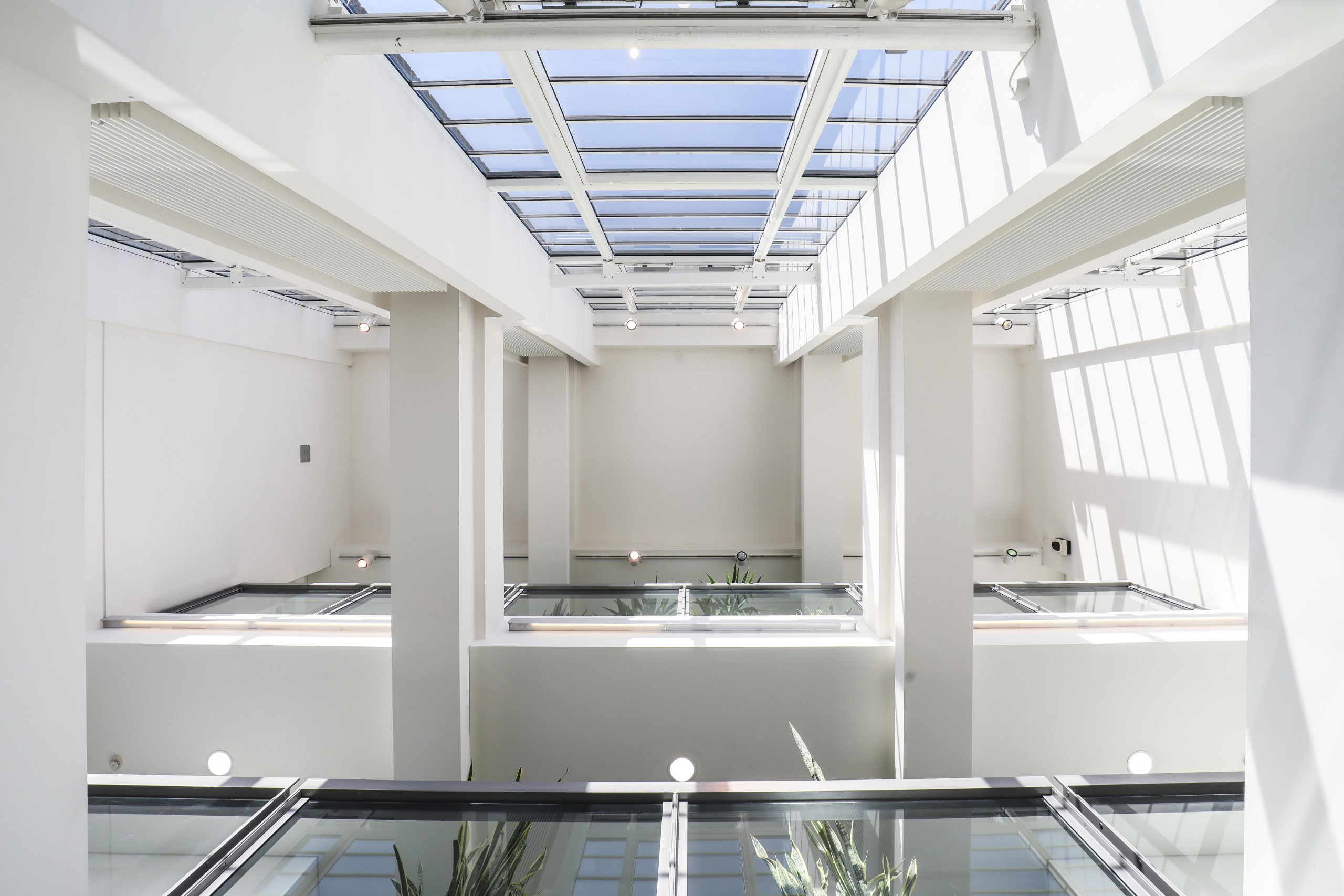 Modern office building interior showcasing a multi-level atrium with large windows and natural light